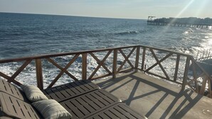 A wooden deck with lounge chairs and a railing overlooking the sea. - Luxury Beach house , infinity, pool, breathtaking view, Surf city,Sunset Park. (La Libertad)