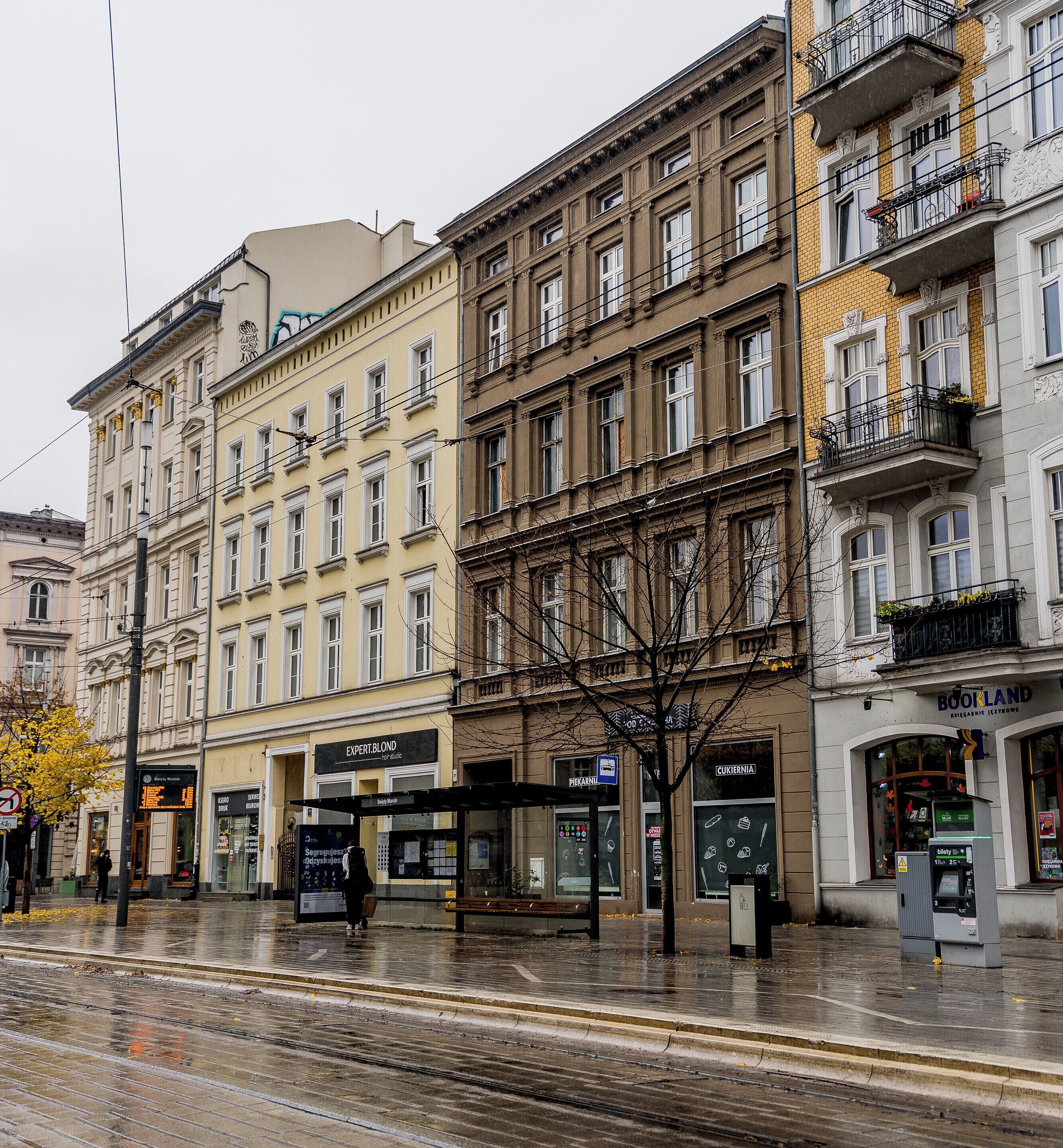 A multi-story building with a ground-level shop and upper residential units.