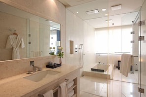 A modern bathroom with a large mirror, dual sinks, a glass-enclosed shower, and a bathtub. - Kinock Pet Hotel (Gyeongju)