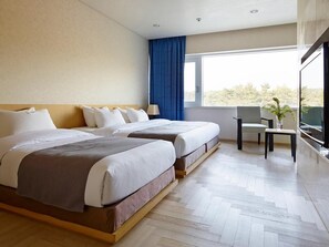 A hotel room with two beds, a window with a view, a small table, and a chair. - Kinock Pet Hotel (Gyeongju)