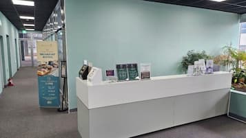 A reception desk with informational brochures and a signboard.