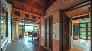 A spacious room with a wooden ceiling, large windows, and a view of the outdoors. - 7BR Luxury Pool Villa - Layan Beach (Tambon Choeng Thale)