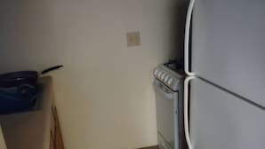 A small kitchen with a refrigerator, stove, and cabinets. - Charming 1-bedroom apartment in amazing Syracuse with AC and heat (Syracuse)