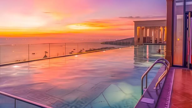 An infinity pool with a view of the sunset over the water. - Anna Hotel Phu Quoc - Sunset Town Tour - Infinity Pool Access (Phu Quoc)