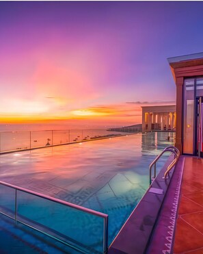 An infinity pool with a view of the sunset over the water. - Anna Hotel Phu Quoc - Sunset Town Tour - Infinity Pool Access (Phu Quoc)