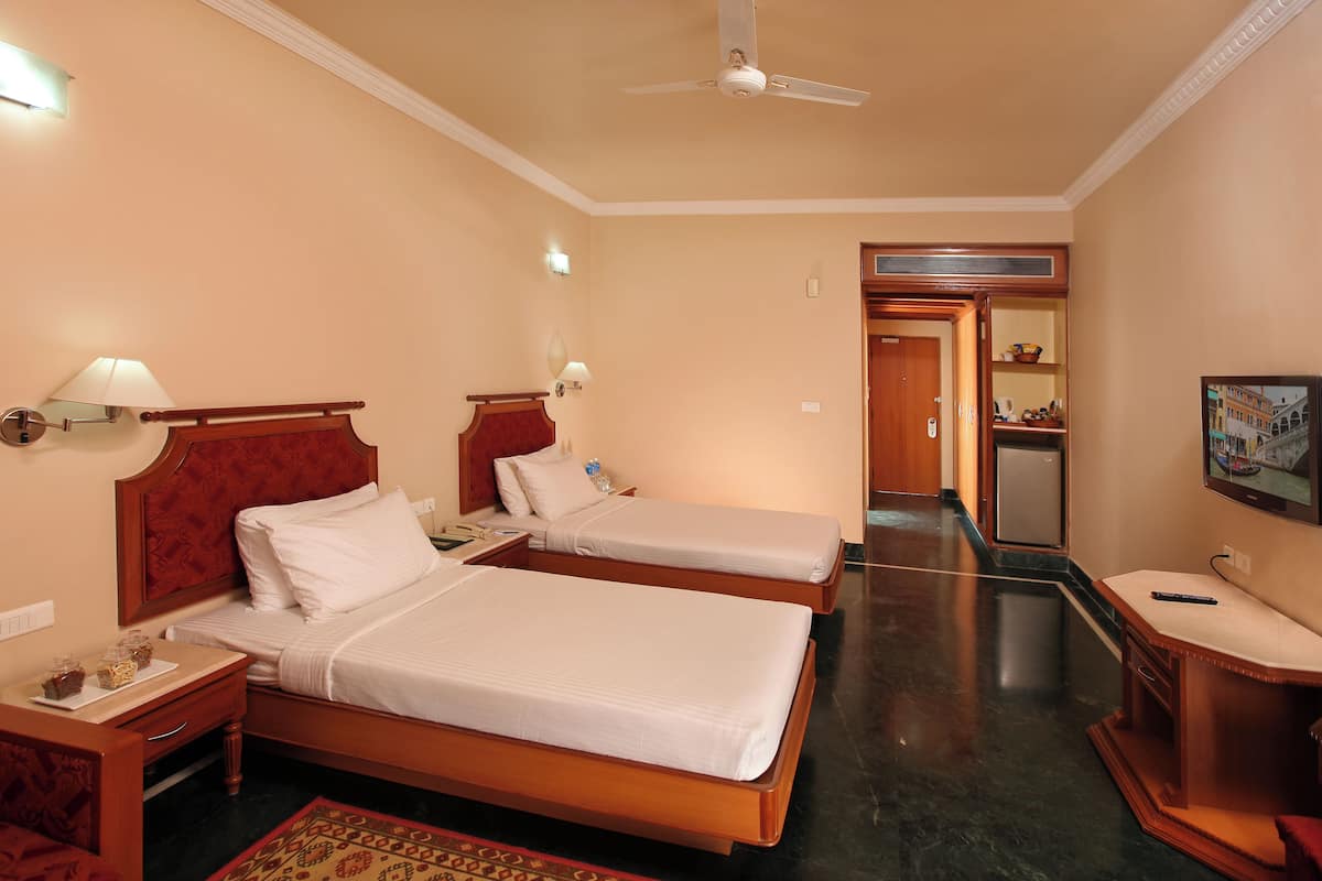 Desk, laptop workspace, iron/ironing board, bed sheets