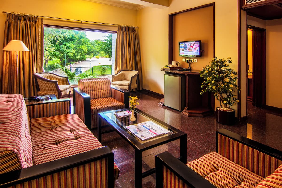 Oasis Pool Signature Suite | Desk, laptop workspace, iron/ironing board, bed sheets