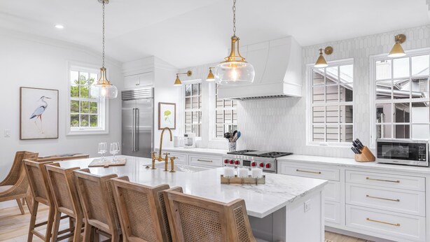 A spacious kitchen with white cabinetry, a large island with seating, and pendant lighting. - Second Wind - Rosemary Beach - Private Pool, Access to Private Beach, Fitness and Tennis Access! (Rosemary Beach)