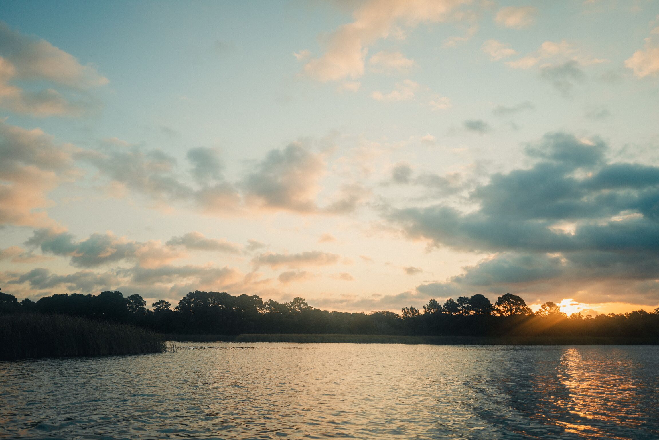 A calm body of water reflecting the sky.