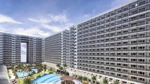 A high-rise hotel with multiple floors, a swimming pool, and a sun deck. - Fancy Pasay City Apartment for Rent - Mall of Asia Nearby Front of Mall Of Asia (Pasay)
