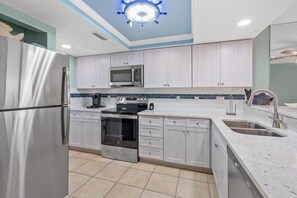 A modern kitchen with stainless steel appliances, a microwave, and a built-in oven. - Luxury Oceanfront Corner Condo-Panoramic Views, Pool, Hot Tub & Walk to Main Street (North Myrtle Beach)