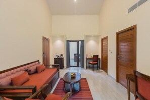 Amplia sala de estar con sofá, mesa de centro y zona de comedor con sillas.