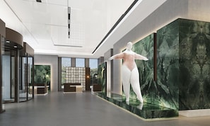 A modern lobby with a glass sculpture, a reception desk, and a view of greenery outside. - Holiday Inn Beijing Daxing Centre By Ihg (Daxing)