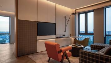 A modern living room with a large TV, a sofa, and a coffee table.