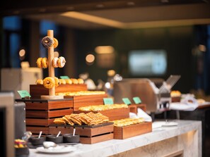 A dessert display with various pastries and waffles. - Holiday Inn Beijing Daxing Centre By Ihg (Daxing)