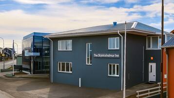 A modern building with a sign reading "The Stykkisholmur Inn".