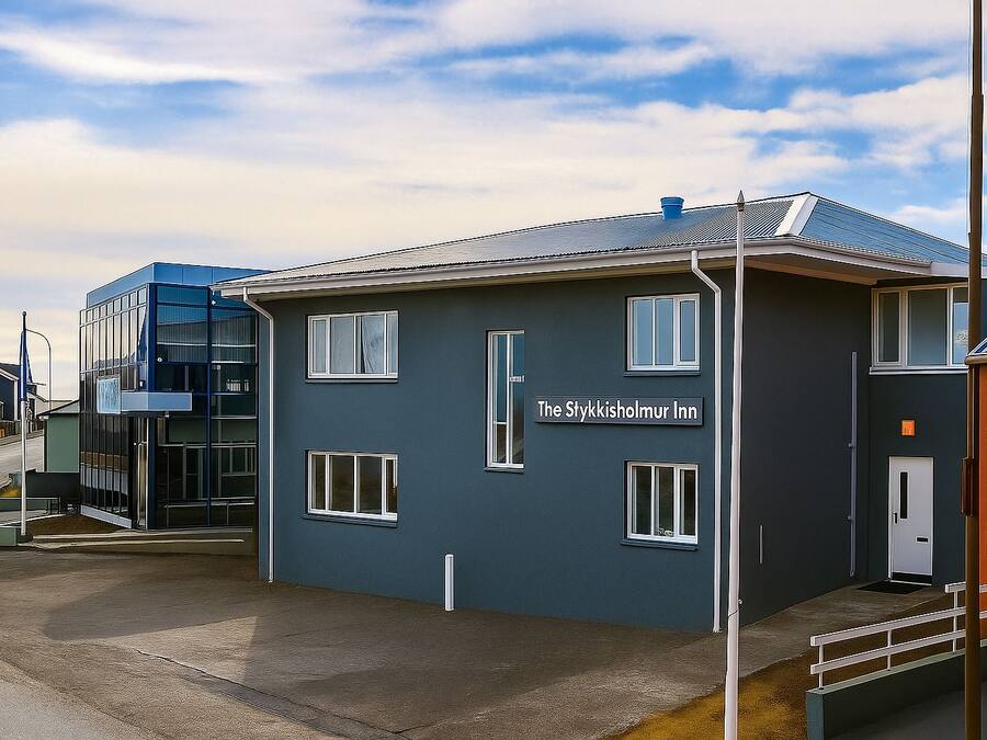 A modern building with a sign reading "The Stykkisholmur Inn".