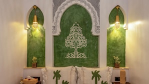 A room with a bed, two nightstands, a decorative wall with a tree design, and two wall-mounted lights. - Riad La Perle Bleue (Marrakech)