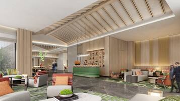 A spacious lobby with a bar area, seating arrangements, and a large window providing natural light.