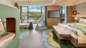 A hotel room with a bed, a small table, a chair, a TV, and a view of the outdoors. - Holiday Inn Puer Jingmai (Pu'er)