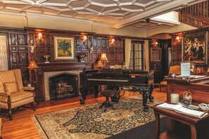 A grand room with a piano, a fireplace, and a large rug. - The Trinity Resort - Scenery (Pembroke)
