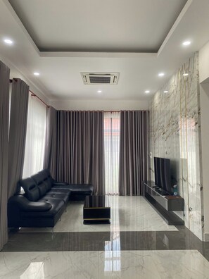 Family Apartment, Resort View | Living area | 30-inch Smart TV with satellite channels - The Palm Resort Phu Quoc (Phu Quoc)