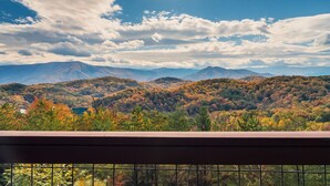 A scenic view from a balcony with a mountain range in the background.