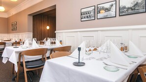 A dining area with tables set for service, framed black and white photographs on the wall, and pendant lighting. - Romantic 2 Person Holiday Home in Give (Give)