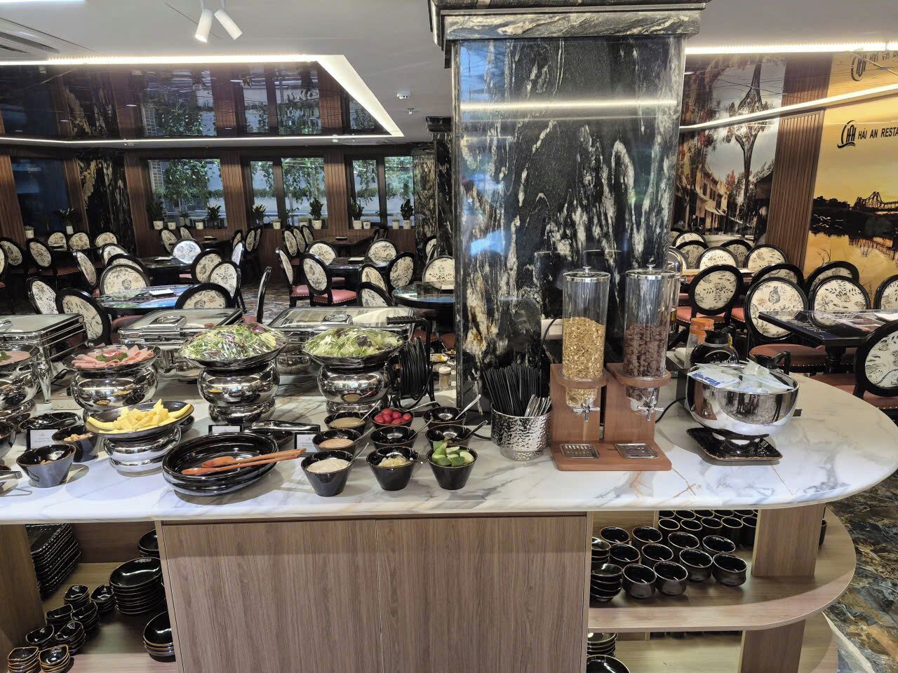 A buffet setup with various food items and condiments.