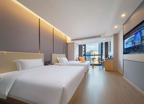 A hotel room with two beds, a desk, and a TV. - Zhangjiajie Hero Boutique Hotel (Zhangjiajie)