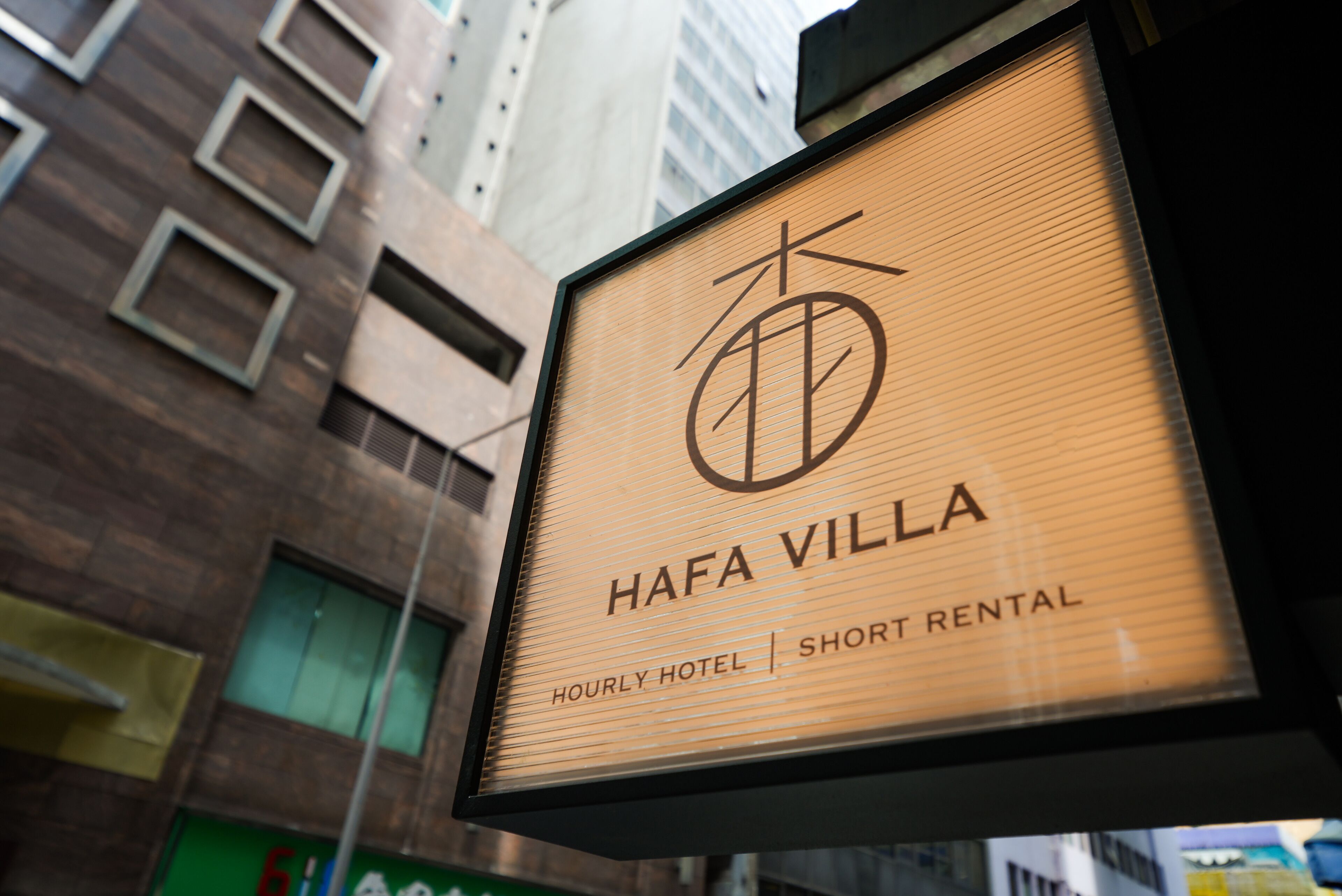 A sign for Hafa Villa, an hourly hotel offering short rentals.
