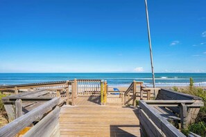 A wooden boardwalk leading to a beach with a clear blue sky. - Dog Friendly, Hot Tub, & Walk to Beach! (Southern Shores)