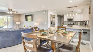 A modern kitchen with a dining area, featuring a large island, built-in appliances, and a ceiling fan. - 7 Mi to Fremont St: Vegas Home w/ Backyard Oasis! (North Las Vegas)