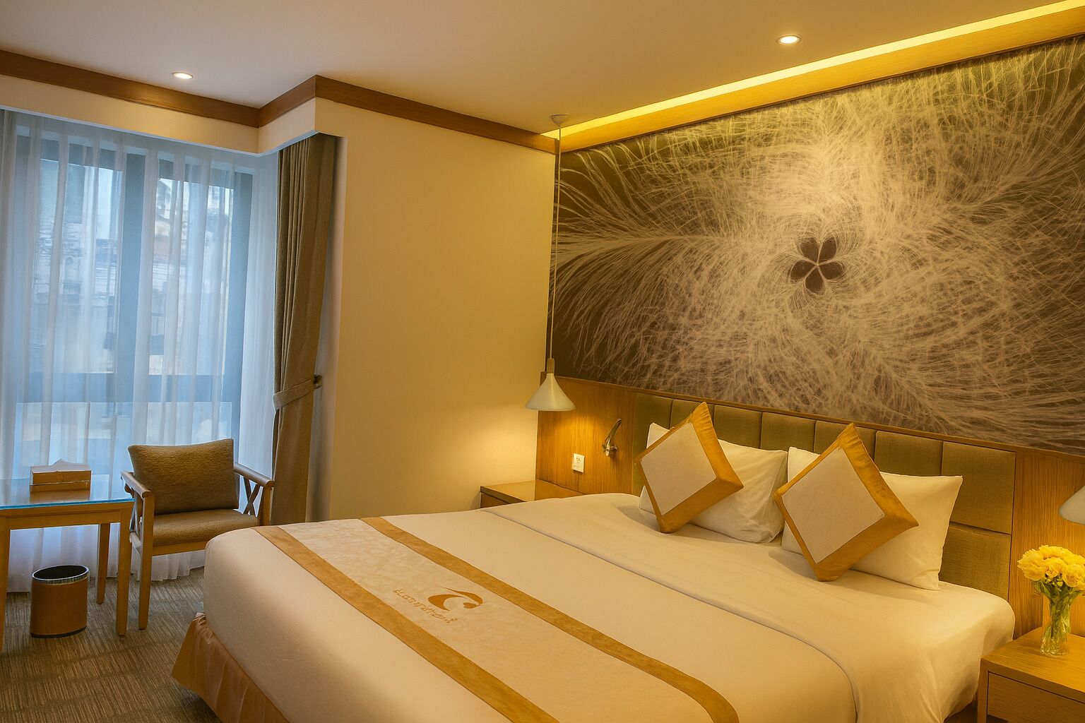 A hotel room with a large bed, a desk, and a chair.