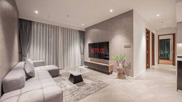 Family Suite, 3 Bedrooms, Club Lounge Access, City View | Living area | 65-inch Smart TV with cable channels, fireplace, Netflix