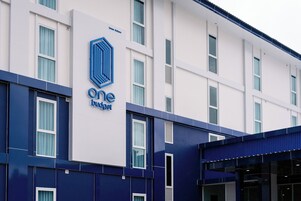 Un edificio de diseño moderno, con un logotipo y señalización destacados para 'One Budget'.