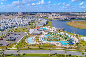 A resort with a swimming pool, a marina, and a parking lot. - Spacious Villa w Pool, Slides & Lush Nature Views (Kissimmee)