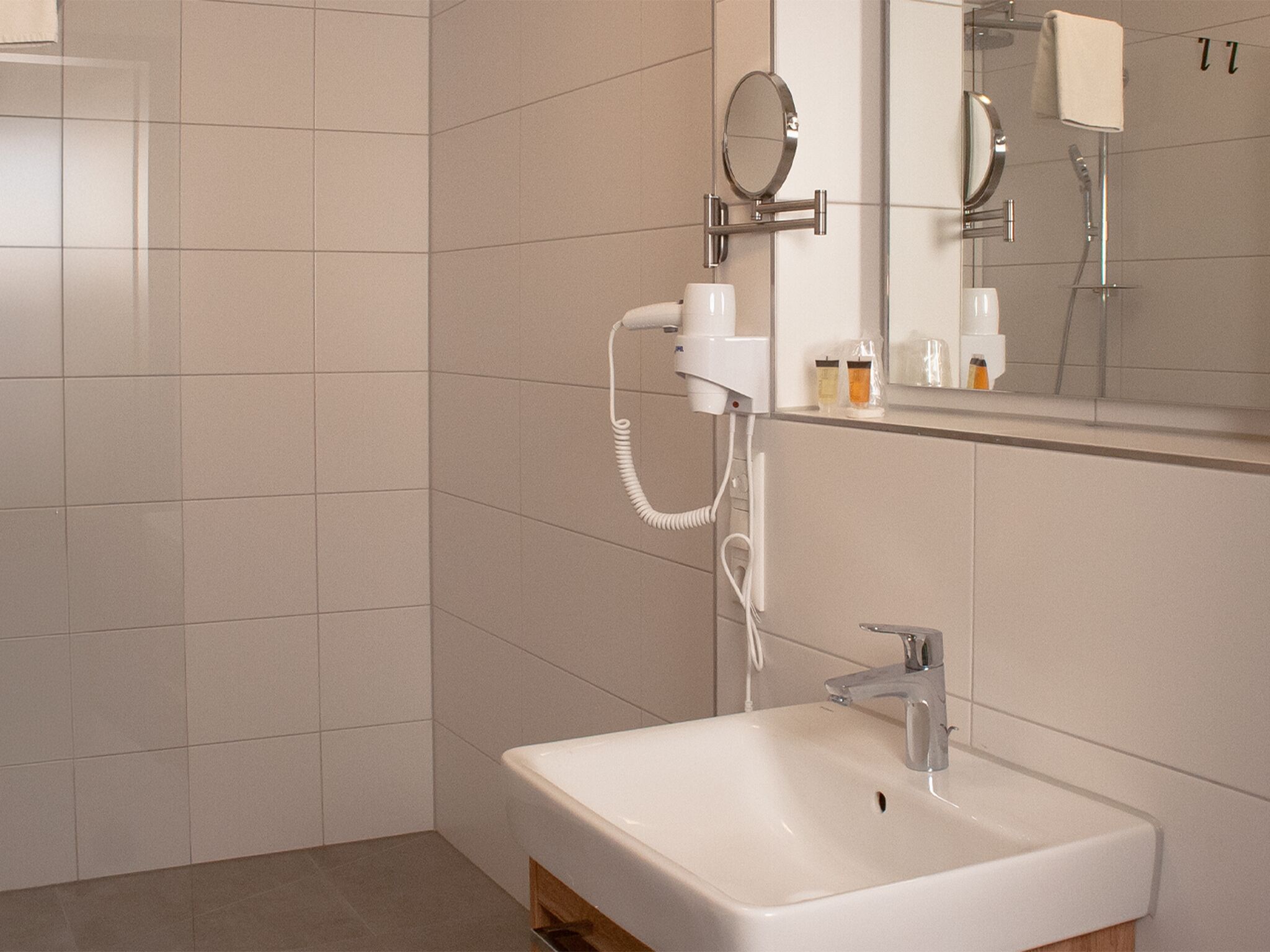 Shower, hair dryer, slippers, towels