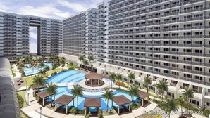 A high-rise hotel with multiple floors, a swimming pool, and a sun deck.