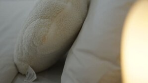 A bed with white pillows and a fluffy white pillow. - Modern Private Retreat | Perfect for Solo Traveler (MacGregor)