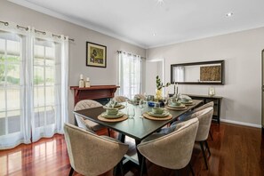 A dining room with a long table set for six, surrounded by six chairs. - Modern Japanese Retreat in Tamborine Mountain (Tamborine Mountain)