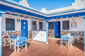 A covered outdoor area with blue and white walls, stone accents, and tiled flooring. - Unit 5 'Ventanas de Lanzarote' with Shared Terrace and Wi-Fi (Yaiza)