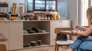 A breakfast bar with pastries, condiments, and beverages. - The Originals City Hôtel Harys (Vichy)