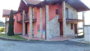 A two-story house with a stone facade, red roof, and balconies. - Rosemary 1 apartment in Agra with pool (Agra)