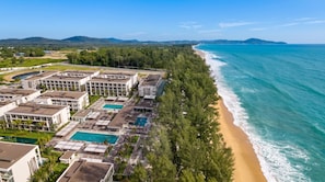 A resort with multiple buildings, a swimming pool, and a beach. - Hotel Riu Palace Phuket - All Inclusive (Mai Khao)