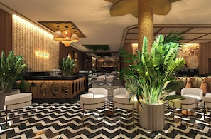 A lobby with a reception desk, seating area, and large potted plants. - Hotel Riu Palace Phuket (Mai Khao)