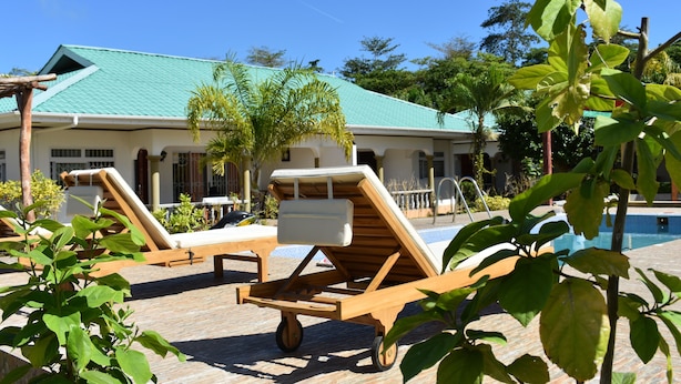 A poolside area with lounge chairs and a pool.