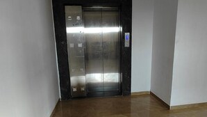 An elevator with a metallic finish and a control panel with buttons. - Fabhotel Ekab Hospitality (Pune)