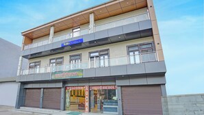 A multi-story building with a sign for 'fab hotels'. - Fabhotel Radha Palace (Vrindavan)