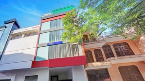 A multi-story building with a 'fab hotels' sign, large windows, and a mix of modern and traditional architectural styles. - Fabhotel Aakarshan Residency (New Delhi)